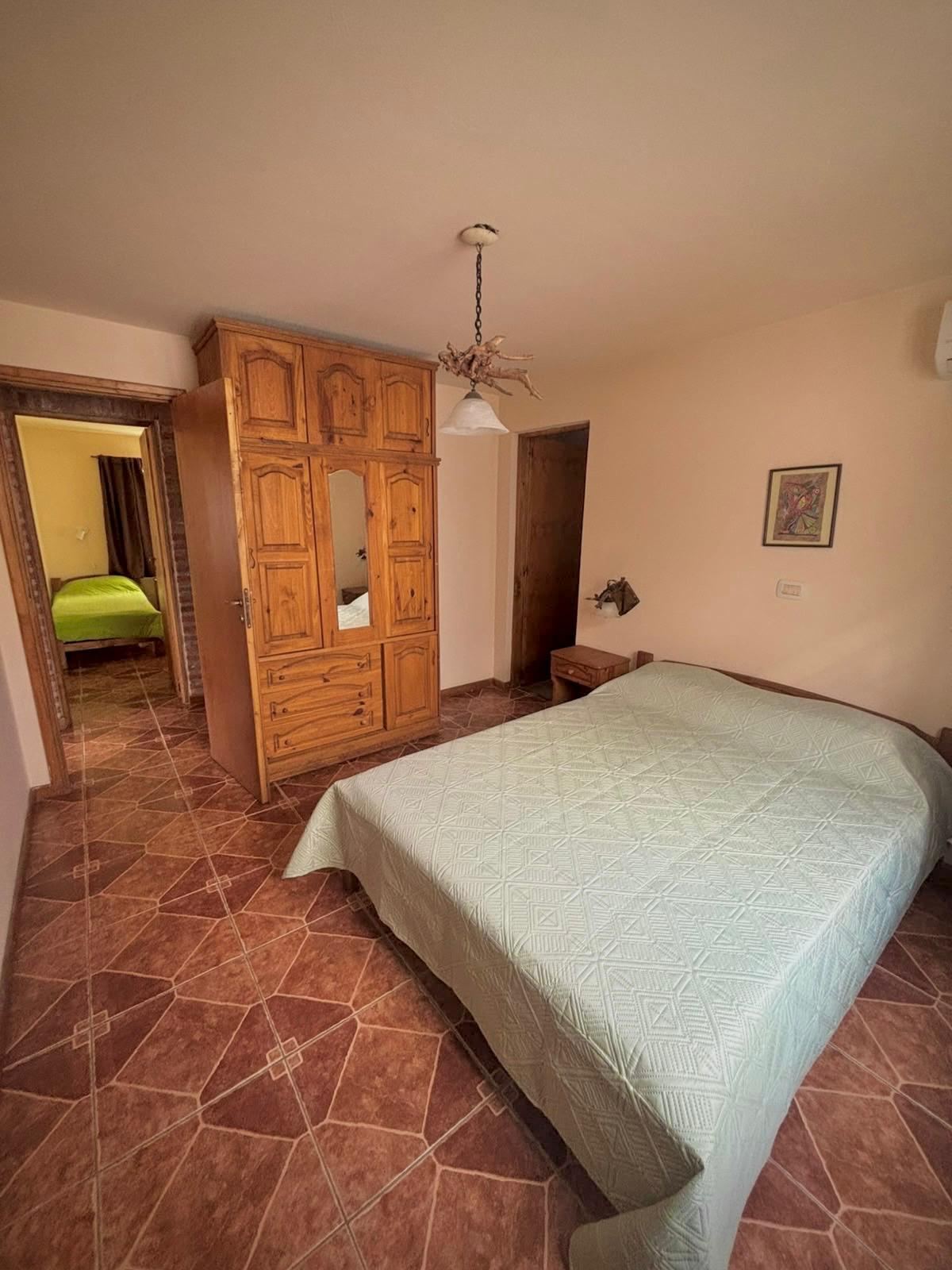 Bedroom with double bed and wooden closet