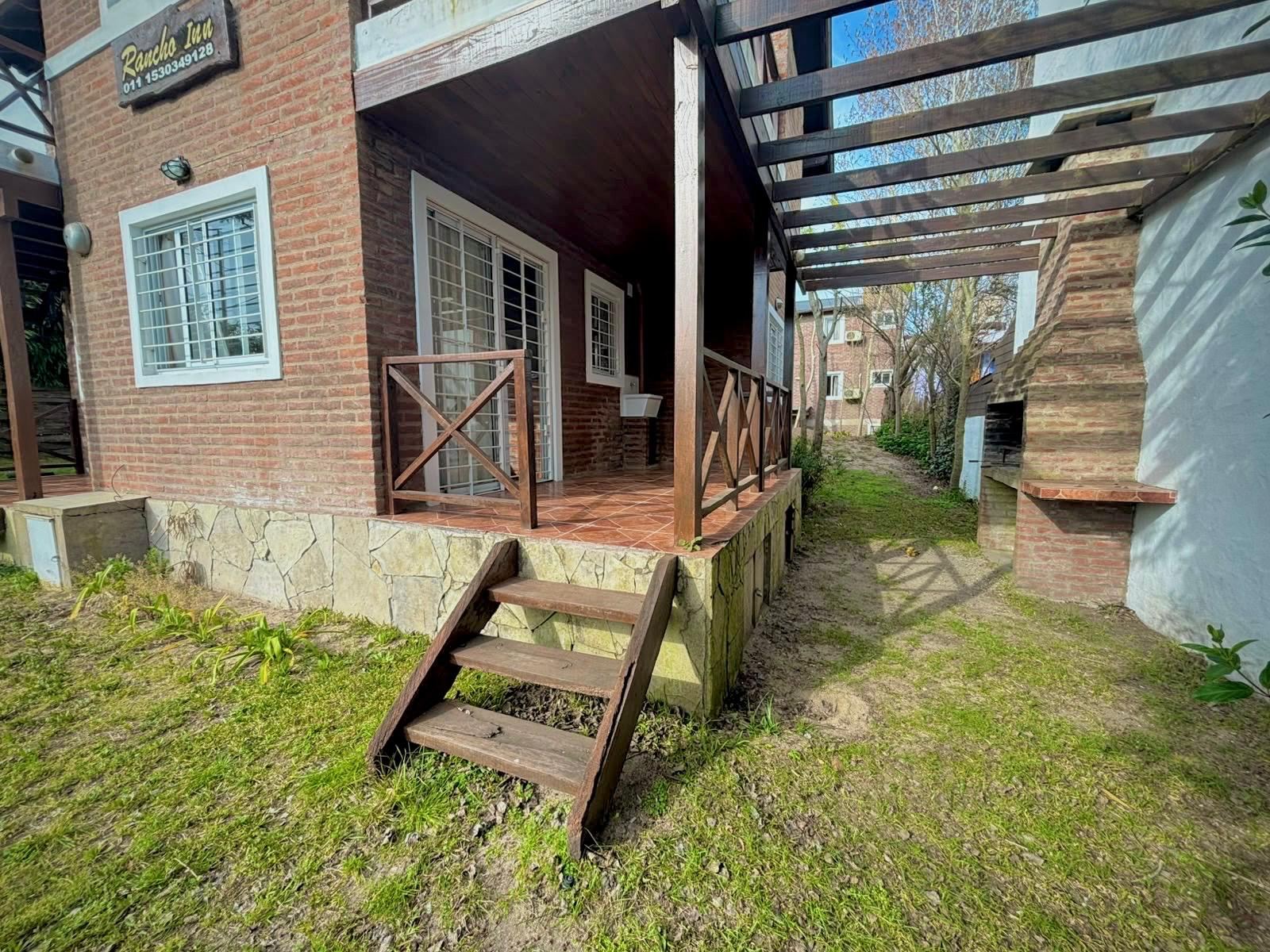 Outdoor porch with brick grill and pergola