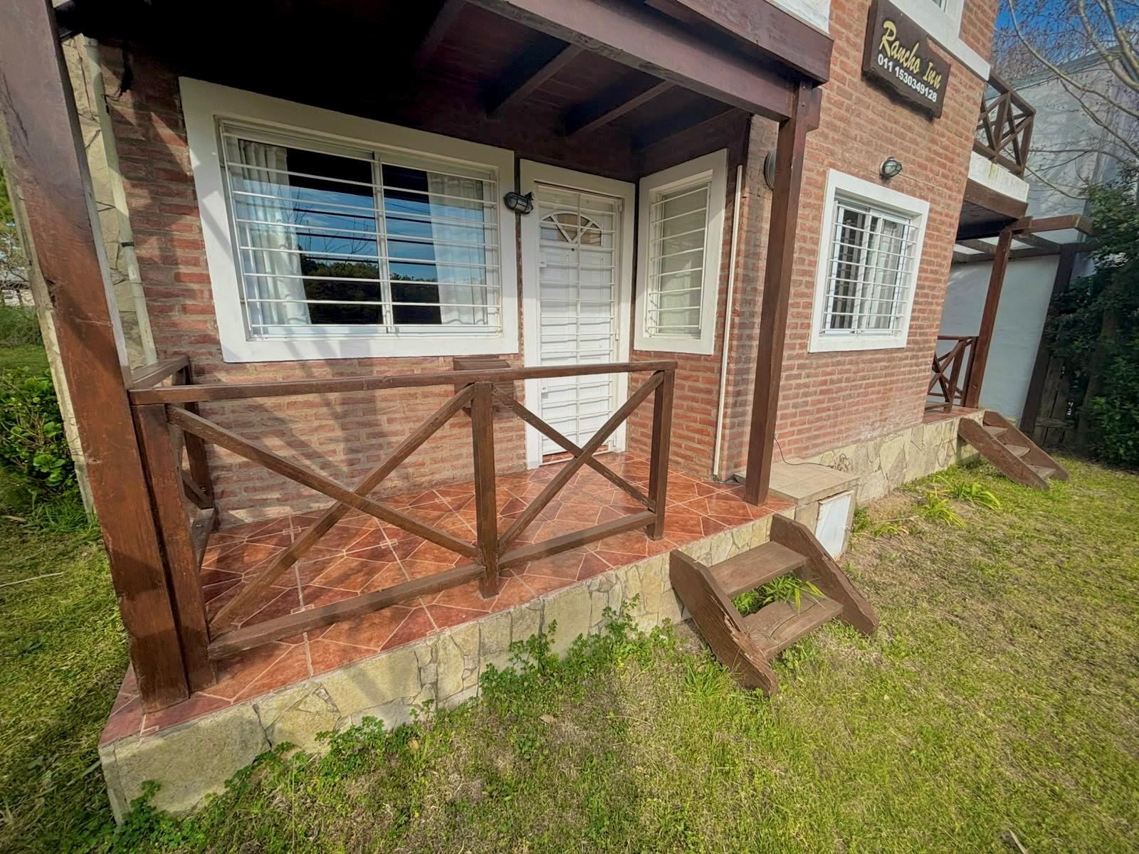 Front of the cabins with porch and garden