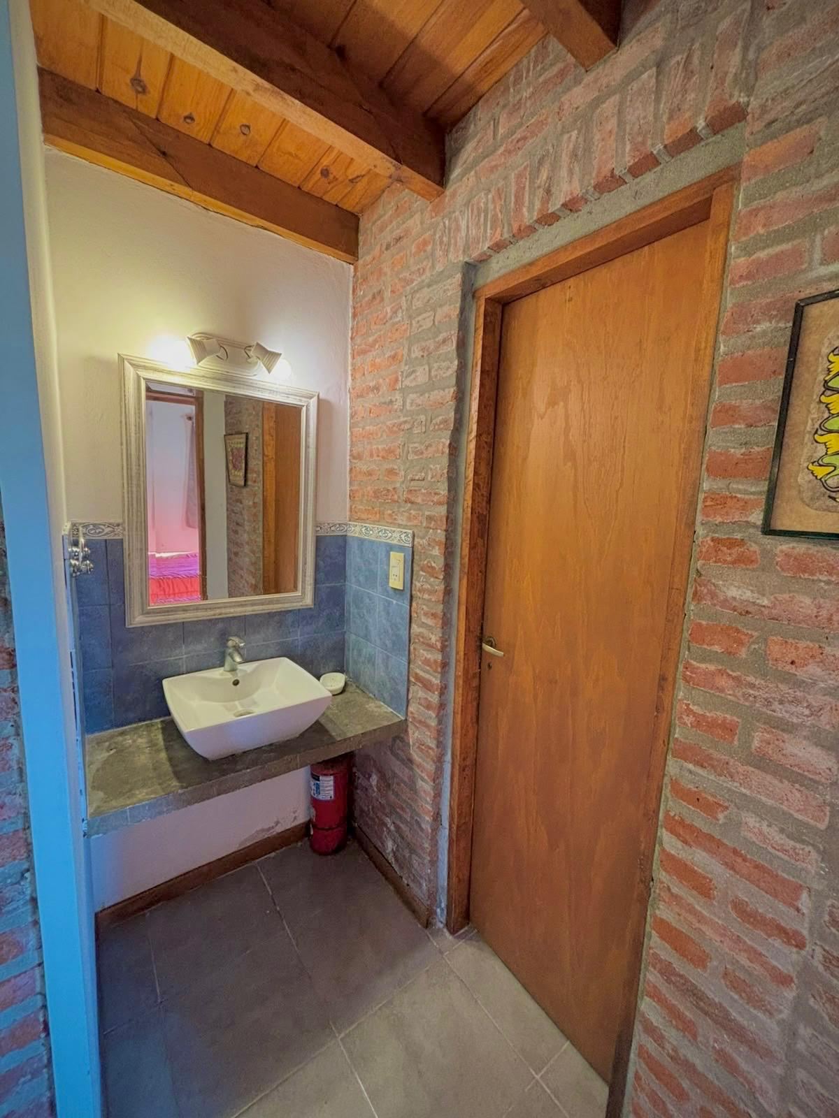 Washbasin with mirror and brick walls