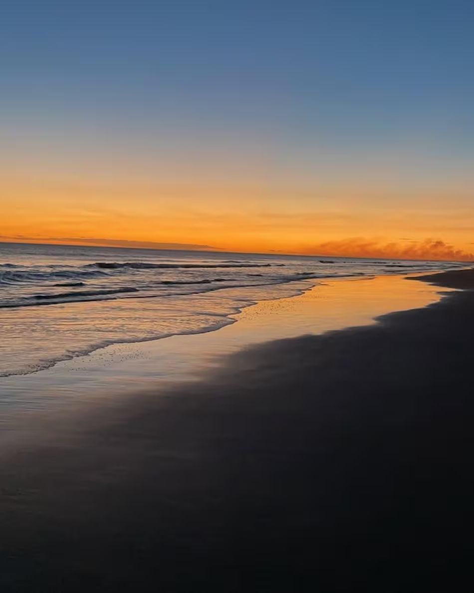Seashore at sunset with an orange sky